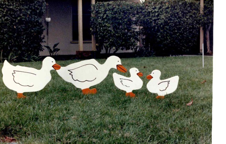 Original four-piece Cutout Ranch duck family on a lawn